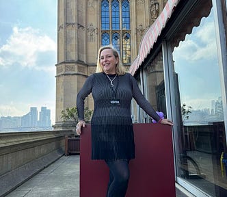 Middle Aged Female Standing in Front of The House of Lords by The Thames