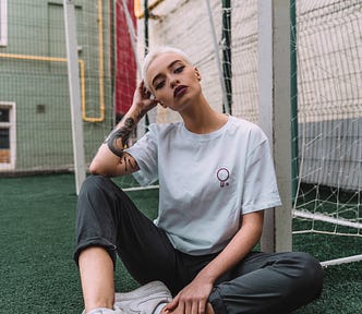 woman sitting by a net on a sports’ field