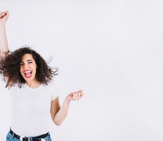 A excited woman raising her fist in the air