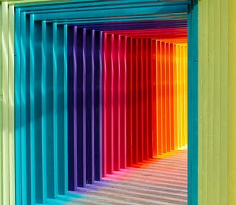 a rainbow of colors forming the shape of a doorway or pathway