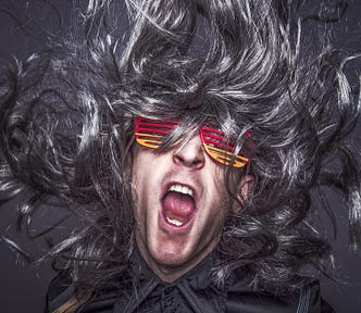 An image depicting a wild haired man screaming.