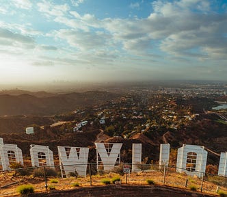 A view of Hollywood from above and behind the famous Hollywood sign, which can be seen in shot, reversed.