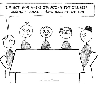 Five people seated around a table. One person says “I’m not sure where I’m going, but I’ll keep talking because I have your attention.”