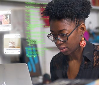 MIT Media Lab researcher Joy Buolamwini working on her computer in the documentary Coded Bias.