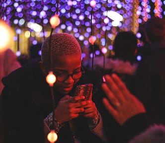person smiling as they check their smart phone