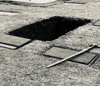 Photo of an open grave by Mark Tulin.