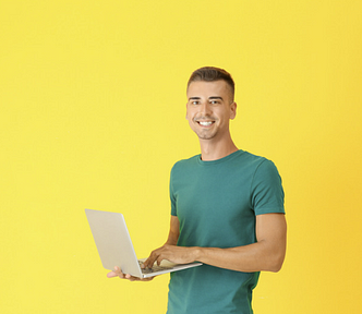 man with a laptop with yellow background writing a strong email