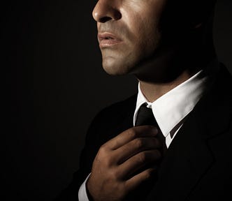 Young man adjusting his tie.