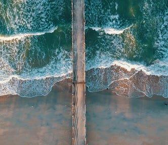 top view photo of sea waves and dock