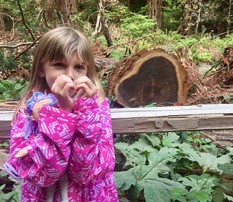 An image of my child Annika in the woods.