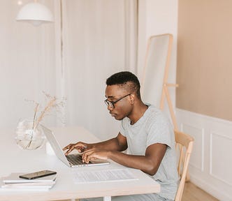 Many typing on laptop computer.