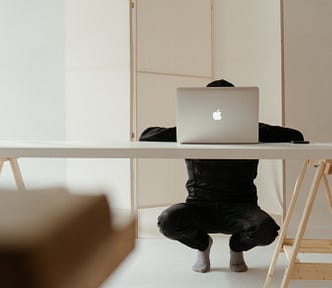 man sitting behind his laptop