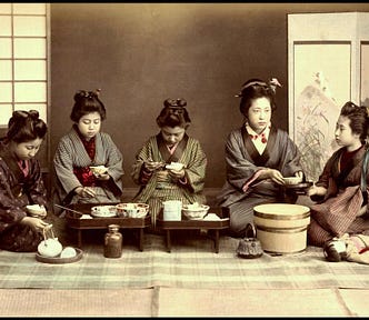 Five pre-modern Japanese women in kimono and old-fashion hairstyles eating lunch together.