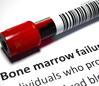 Test tube with blood sample on a document that says “bone marrow failure.”