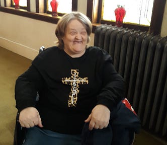 Woman in faith shirt smiling