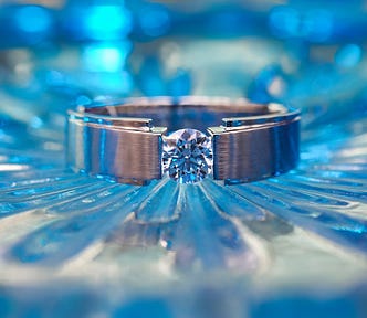 Diamond ring, blue diamonds on table