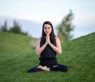 Girl meditating on grass