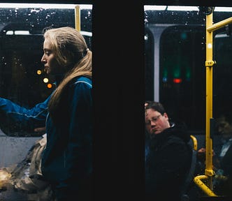 a-woman-standing-inside-bus