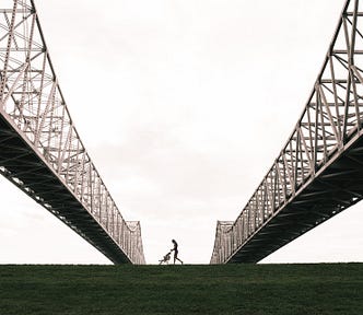Two metal bridges with the silhouette of a person with a pram walking between them, Lisa S. Gerard, Medium