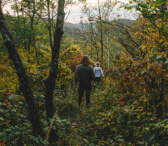 women walking through the woods