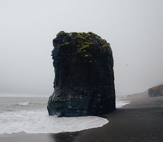A rock monolith surrounded by the sea.