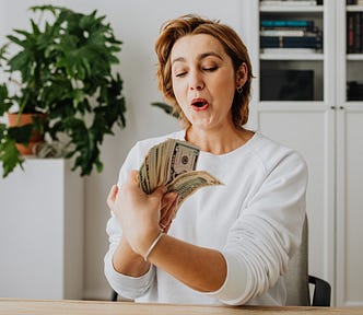 Beautiful woman holding lots of money