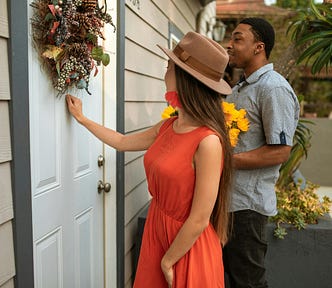 Man and woman knocking on a door