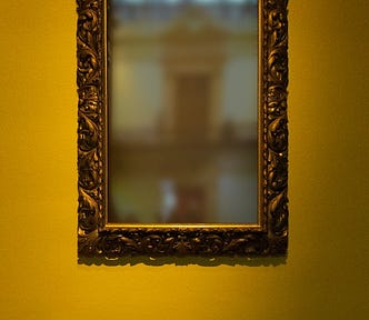 A brass picture frame with a blurry image in the center.