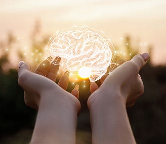 Conceptual illustration of a person holding a drawing of a brain.