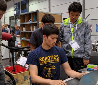 Students programming a robot during the Amazon Picking Challenge, 2016