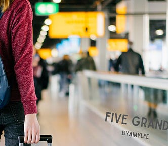 Woman walking away in airport.