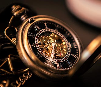 close up of gold pocket watch