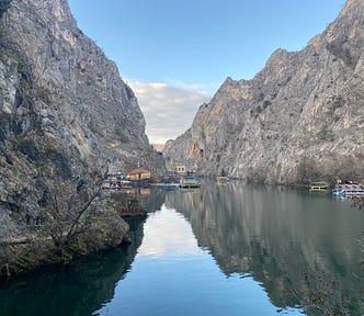 Two steep cliffs drop into a body of water below