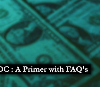 A blurred dark green-blue pile of one dollar bills with white title text “CBDC: A Primer with FAQ’s”