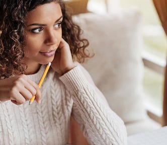Photo of smiling female, holding pencil
