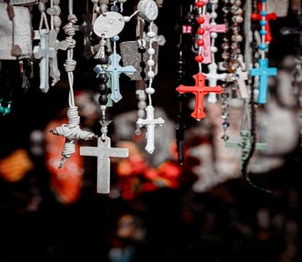 A collection of plastic rosaries hanging down.