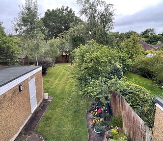 A beautiful and green English garden taken from a window upstairs.