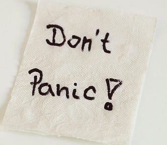 A handwritten note on a napkin, “Don’t Panic!”.