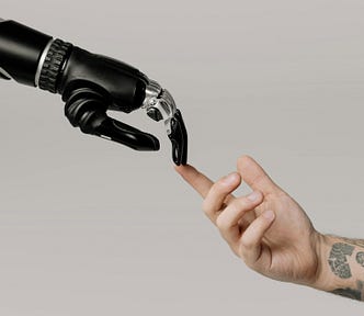 Robotic hand and human hand reaching each other