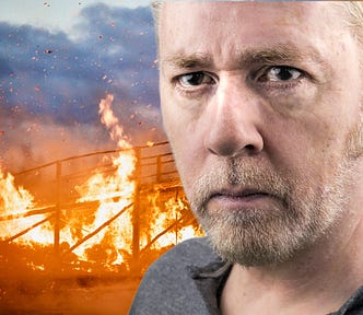 head shot of intense looking middle aged white man in front of burning bridge