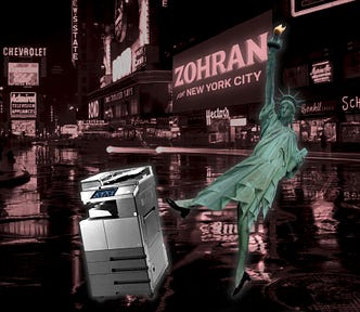 A nighttime scene in Times Square in the 1960s, with the Camel ad replaced with a Zorhan Mamdani ad. In the foreground the Statue of Liberty is kicking a photocopier. Image: lee (modified) https://commons.wikimedia.org/wiki/File:160711_N610_%EC%9A%B0%EC%B8%A1%EB%A9%B4.jpg CC BY-SA 4.0 https://creativecommons.org/licenses/by-sa/4.0/deed.en