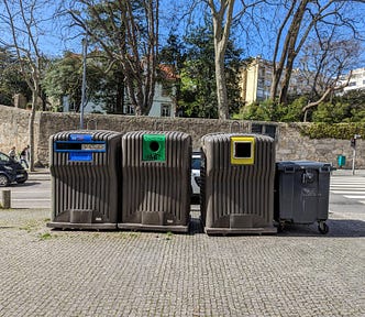 Recycling bins in Porto: the opening indicates what goes where, which supports the national color coding standard.