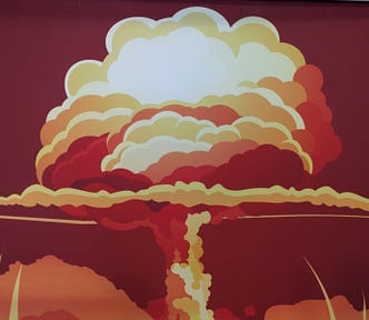 Red, orange and white image of a Nuclear Bomb Test Explosion.