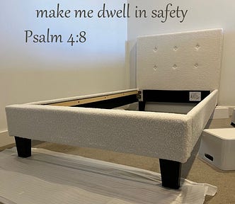 A white bed frame under construction. The words from Psalm 4:8 (In peace I will lie down and sleep: for you alone, Lord, make me dwell in safety) are overlaid at the top of the image.