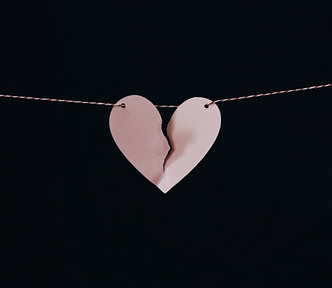 Broken heart hanging from a string