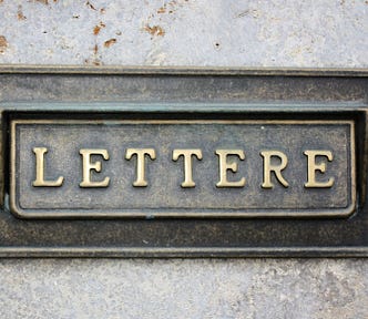 Image of a metal mail slot, which is labeled “Lettere.”