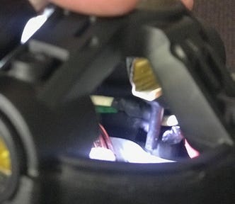 Top of motor housing showing plastic pin with wires routed behind it