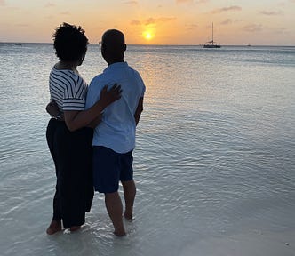 Black married couple on a beach in Aruba. K. Joseph and hubby. Image © K. Joseph.
