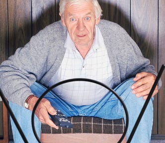 Picture of an older white man staring at an oldTV with rabbit ears, holding a remote, and looking like a zombie.