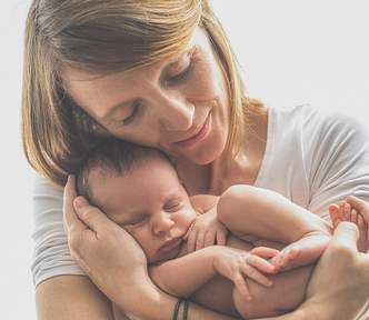 Photo of a mother holding her child in her arms.